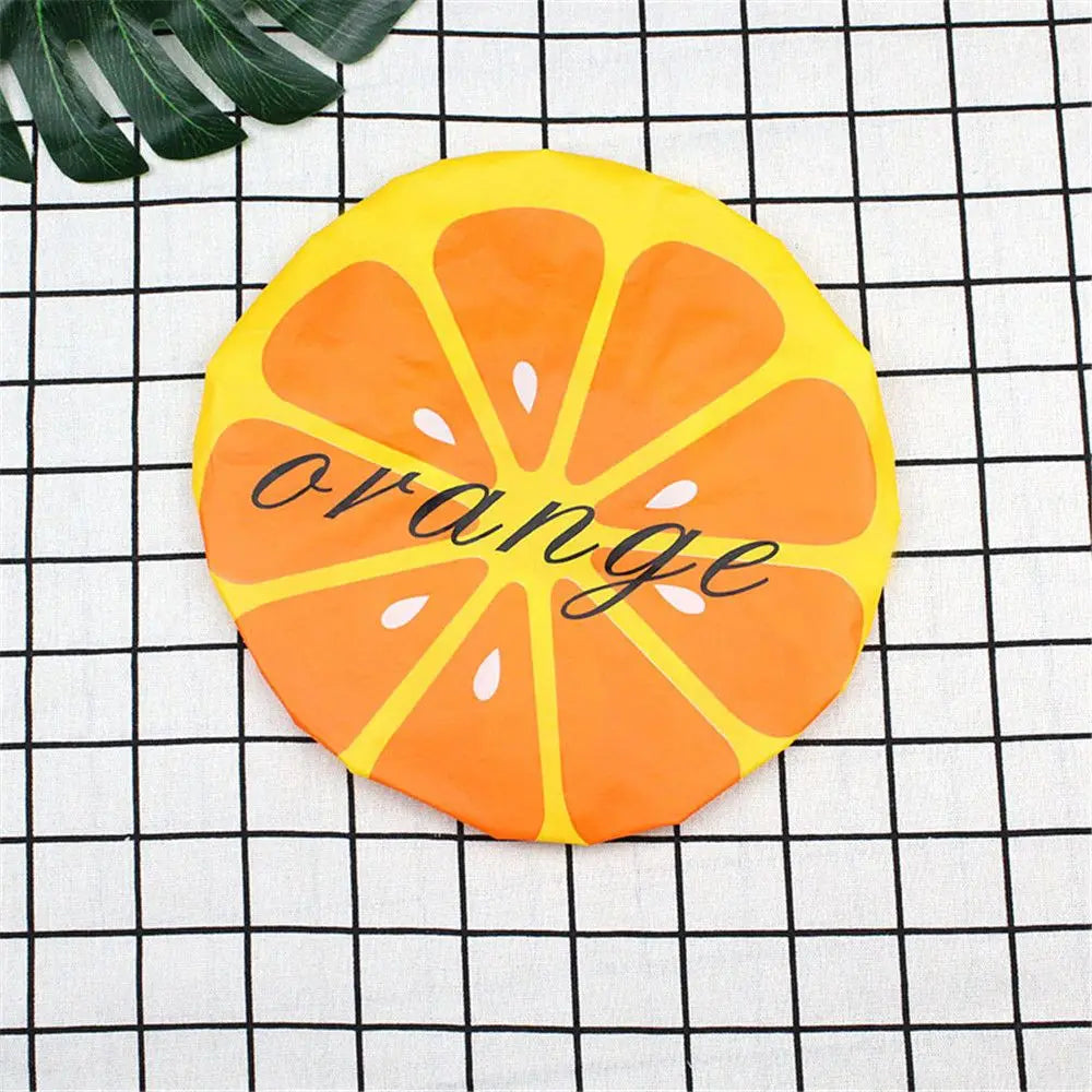 A bright orange citrus fruit design on a yellow background used as a waterproof shower cap.