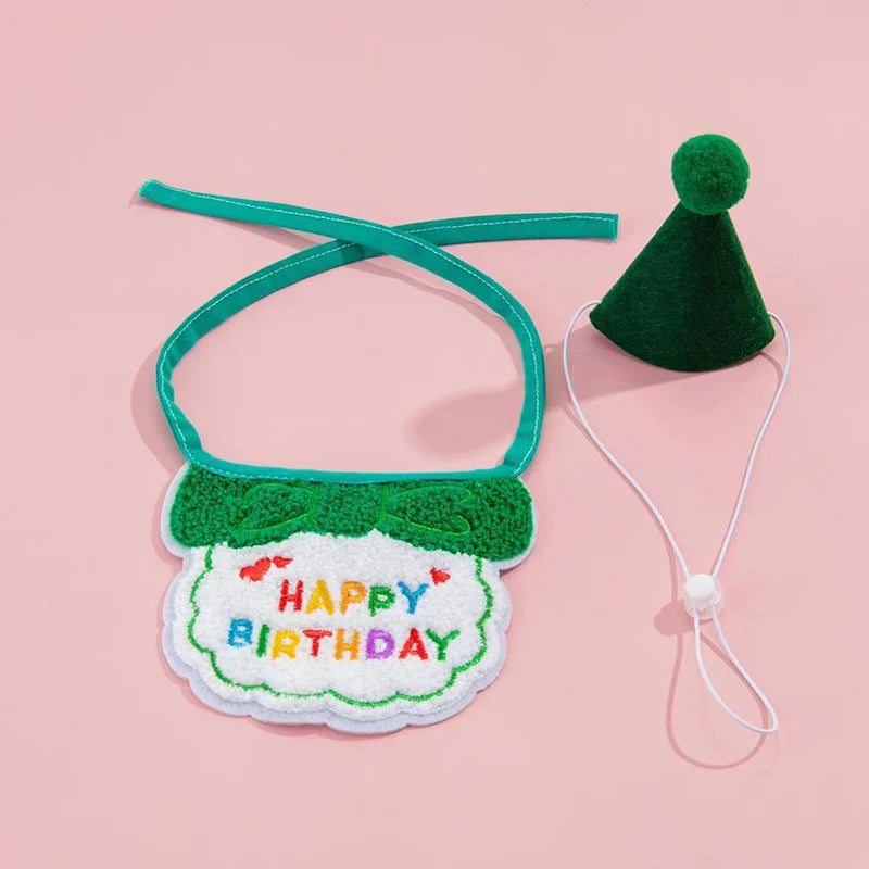 A green pet birthday party hat and bib set for cats and small dogs with a white tag.