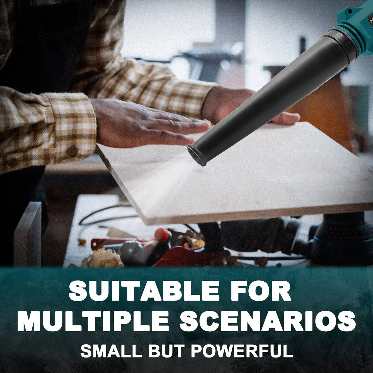 A hand is using a black cordless leaf blower with an adjustable nozzle to blow debris on a light-colored surface.