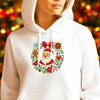 White hoodie featuring a red and white Christmas embroidery design with Santa and holly.
