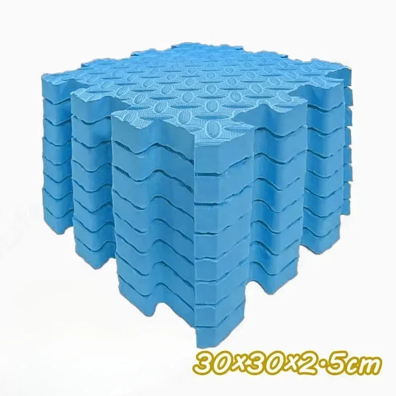 A stack of blue interlocking foam play mats for babies and toddlers.
