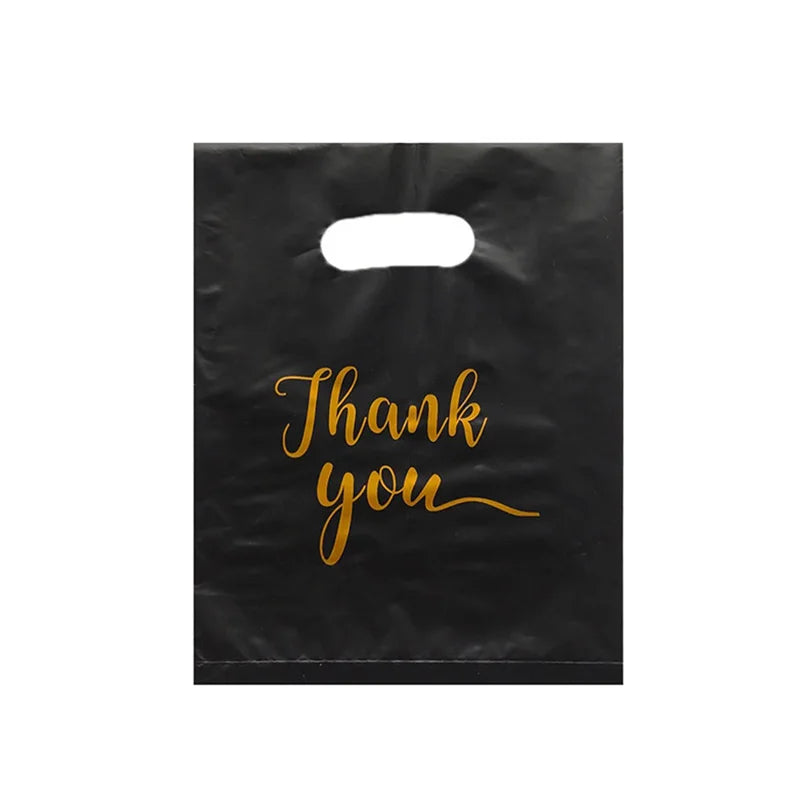 Black gift bags with handles featuring gold script text that reads Thank you