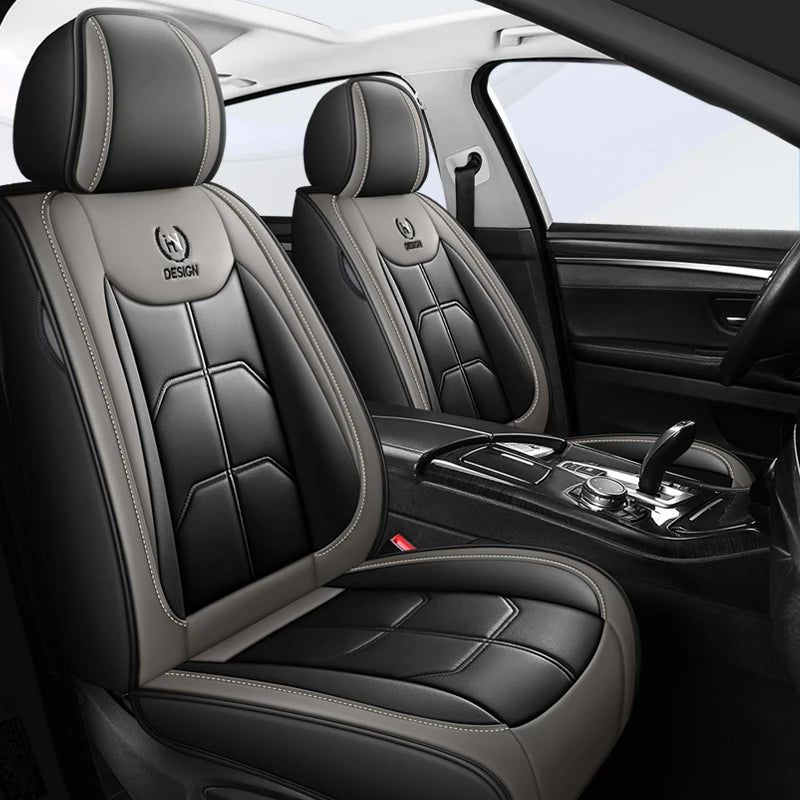 Interior view of a black car seat with gray stitching and leather upholstery.