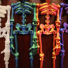 A display of poseable luminous skull fridge magnets in white, teal, and orange colors.