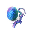 A vibrant blue and purple dragon egg and figurine set featuring textured scales.