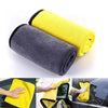 A yellow microfiber car cleaning towel next to a gray one, showing different angles of the lint-free cleaning cloth.
