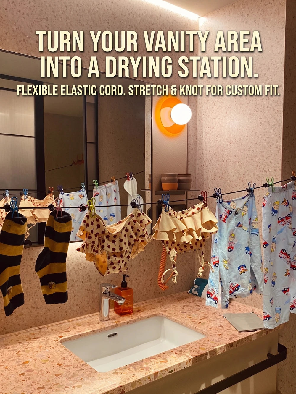 A vanity area setup showing a flexible elastic cord drying station with various clothing items.