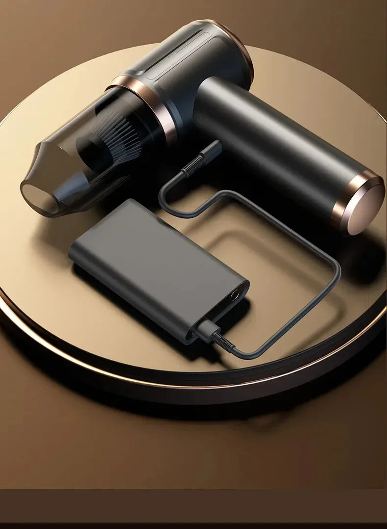 A black cordless handheld vacuum cleaner with a hose and charging cable resting on a round wooden surface.