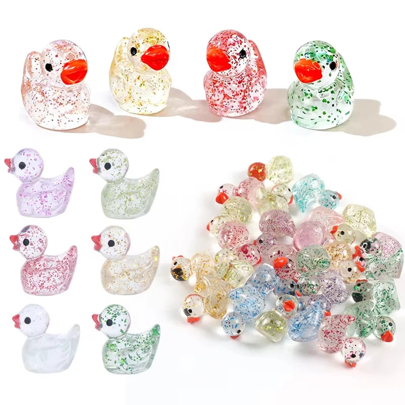 A collection of ten glitter resin duck figurines in various colors and finishes.