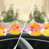A collection of rubber duck car decorations featuring princess crowns, sunglasses, and pearl necklaces.