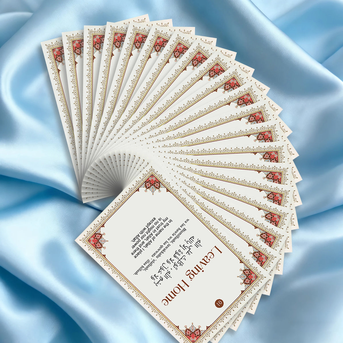 A fan of Islamic dua cards showing a stack of cards with decorative borders and Arabic text