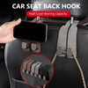 A hand is attaching a dual suede hook car seat back storage hook to a black car seat for securing bags.