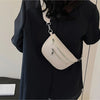 A beige multi-pocket PU leather waist bag with a silver chain strap is shown against a black garment.