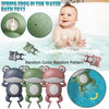 A baby is playing with a green wind-up swimming frog bath toy in water, surrounded by various frog toys.