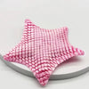 A pink 3D printed articulated starfish fidget toy with a textured, quilted surface.