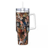 A silver insulated stainless steel tumbler with a clear lid featuring a collage of faces.