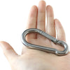 A hand holds a heavy-duty stainless steel ceiling mount hanging kit.