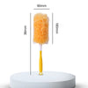 A yellow electrostatic duster with an orange fluffy head is shown standing on a white circular platform.