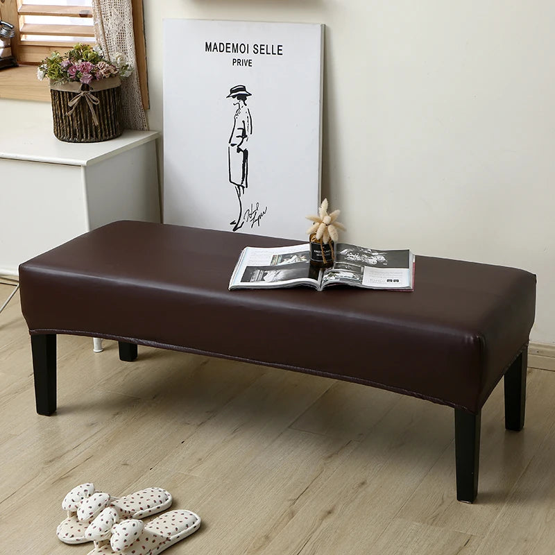 A dark brown waterproof PU stretch bench cover is placed on a light wooden floor.