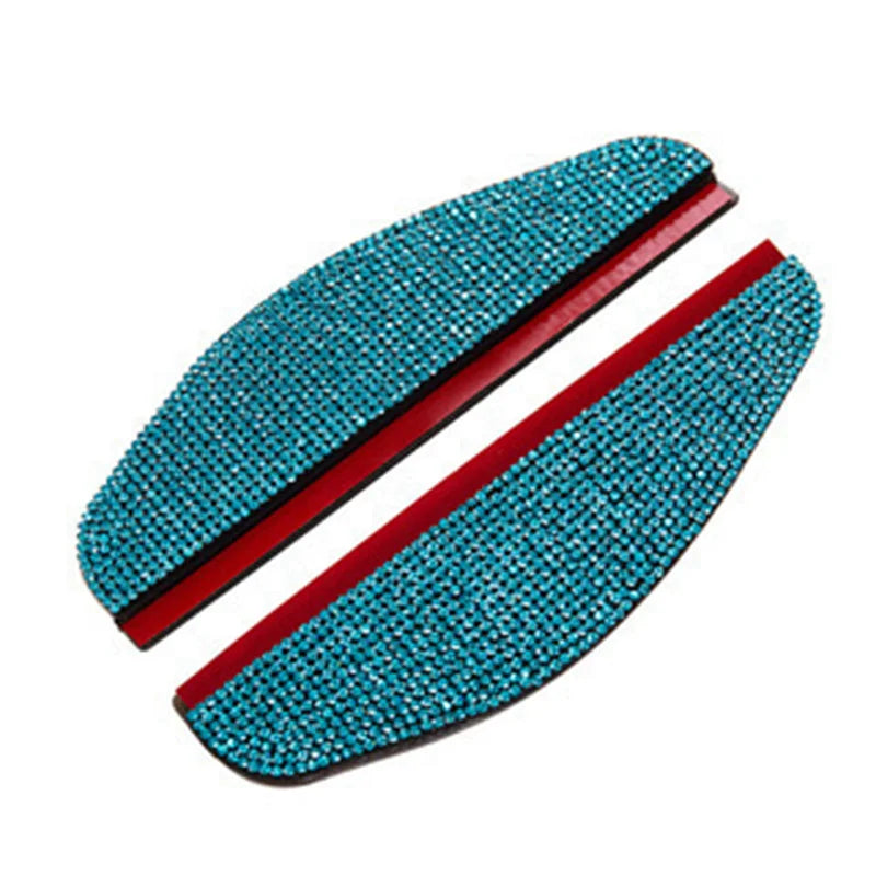 A pair of turquoise rhinestone car rearview mirror rain guards.