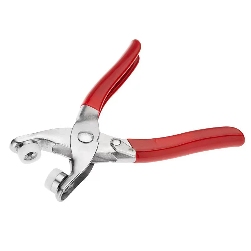 A pair of red and silver snap fastener pliers for clothes and DIY projects.