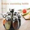 A set of rotating glass spice jars with a rack, showing various dried spices like pepper and herbs.