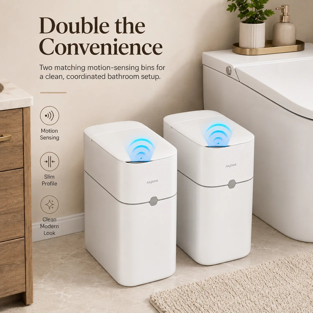 Two white motion-sensing bins for a bathroom setup next to a toilet.