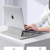 A laptop is placed on a slim sleeve case designed to transform it into a stand for ventilation and dissipation.