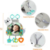 A baby car seat toy featuring a mirror, teether, and crinkle play elements with a supporting board and hanging string.