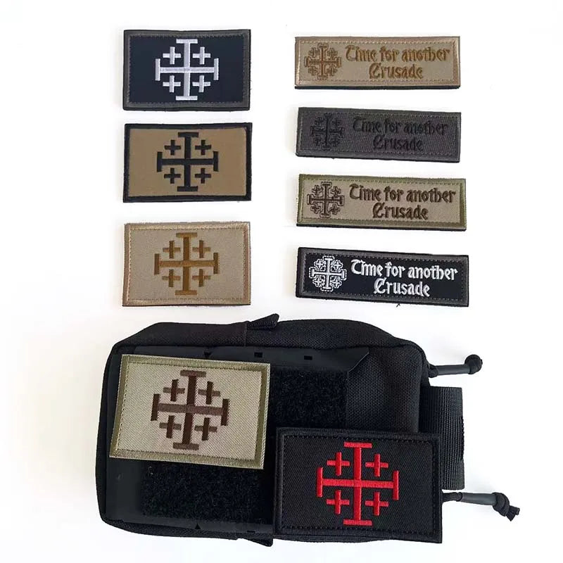 A collection of embroidered tactical patches featuring the Knights Templar cross design on various colored fabric backgrounds