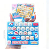 A blue set of cartoon keycaps and fidget items for a keyboard, shown next to a packaging card.