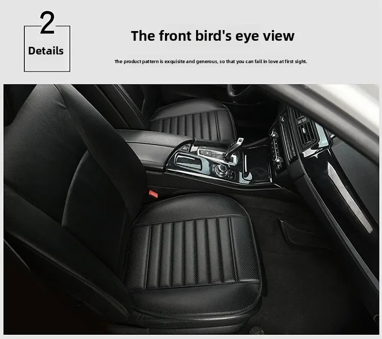Interior view of a car seat with black leather upholstery and a patterned seat cover installed.
