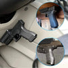 Close-up view of a black pistol with a magnetic gun mount and quick-release lock for car or home use.