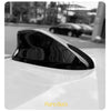 Piano Black sleek shark fin antenna cover for a vehicle, shown in profile.