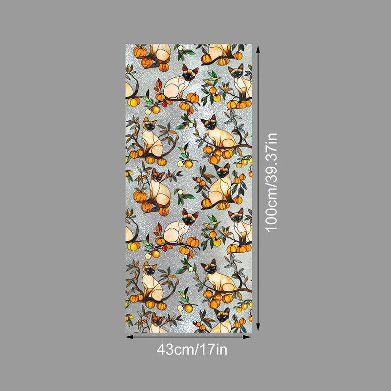 A vertical sheet of floral stained glass window film featuring cats and foliage in warm orange and yellow tones.