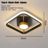 A square modern LED ceiling light fixture with a black frame and gold accents mounted on a wall.