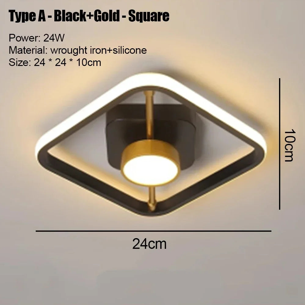 A square modern LED ceiling light fixture with a black frame and gold accents mounted on a wall.