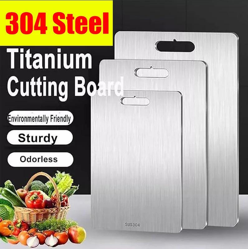 A set of two stainless steel titanium cutting boards displayed on a black background with fresh produce.