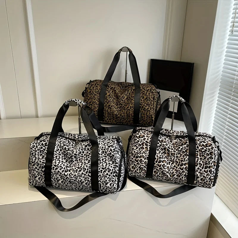 A collection of leopard print weekender tote bags with black straps displayed on a white surface.