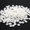 A pile of 100 clear white acrylic pearl spacer beads for jewelry making.