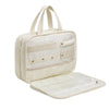 A cream-colored portable hanging toiletry bag with a clear plastic cover and multiple pockets.