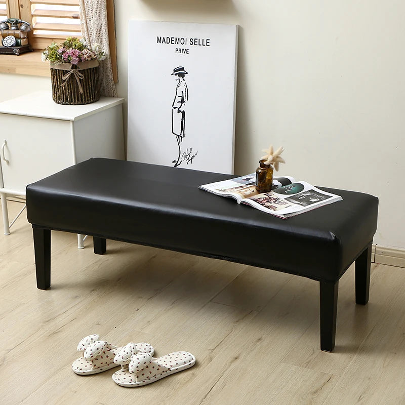 A black waterproof PU stretch bench cover is shown on a wooden floor.