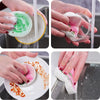 Hands are shown using eco-friendly wood pulp dish sponges to clean dishes in a kitchen sink.