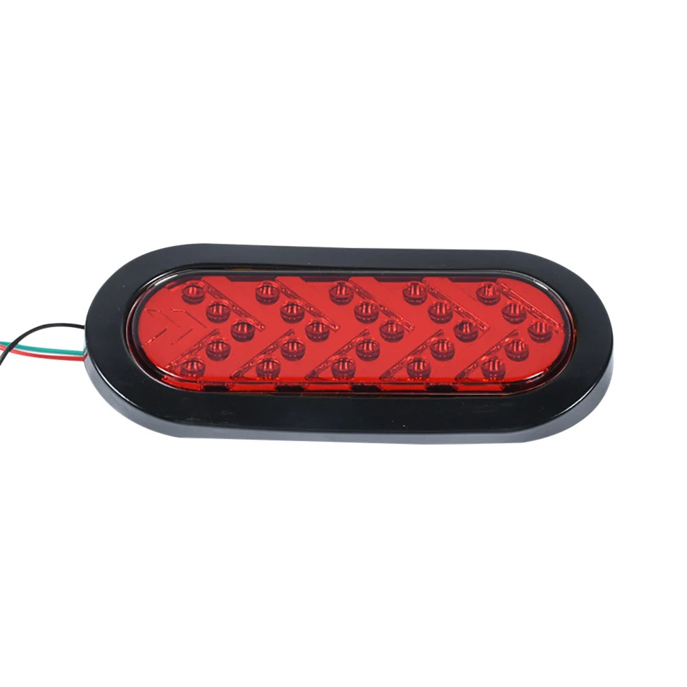 A black oval LED trailer tail light with a red lens and dynamic amber arrow turn signal.