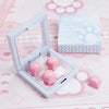 A clear plastic case holds pink silicone cat paw and heart keycaps for MX switches on a pink background.