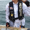 A person wearing a white shirt and black vest holds a squid jig protector kit with carabiner on a wooden surface.