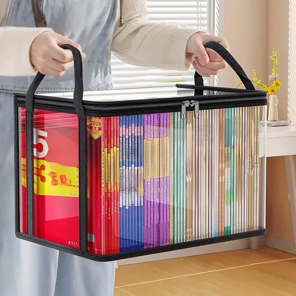 A black storage box with a clear plastic lid filled with numerous colorful books being held by a person.