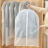 A person is hanging transparent zippered garment storage bags on a wooden rack.