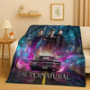 A dark purple and blue blanket featuring characters and a car from the Supernatural TV show.
