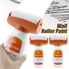 A hand is applying Wall Roller Paint, a white roller with an orange handle and paint, to a surface.
